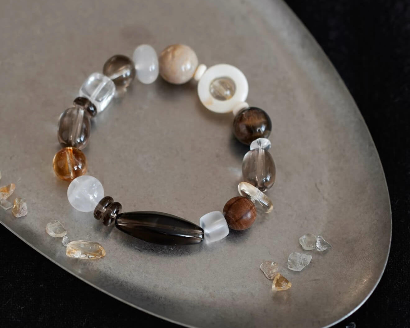 Hand-stringing natural crystal beads with intention for energy protection - CIRCLEARA artisanal craft