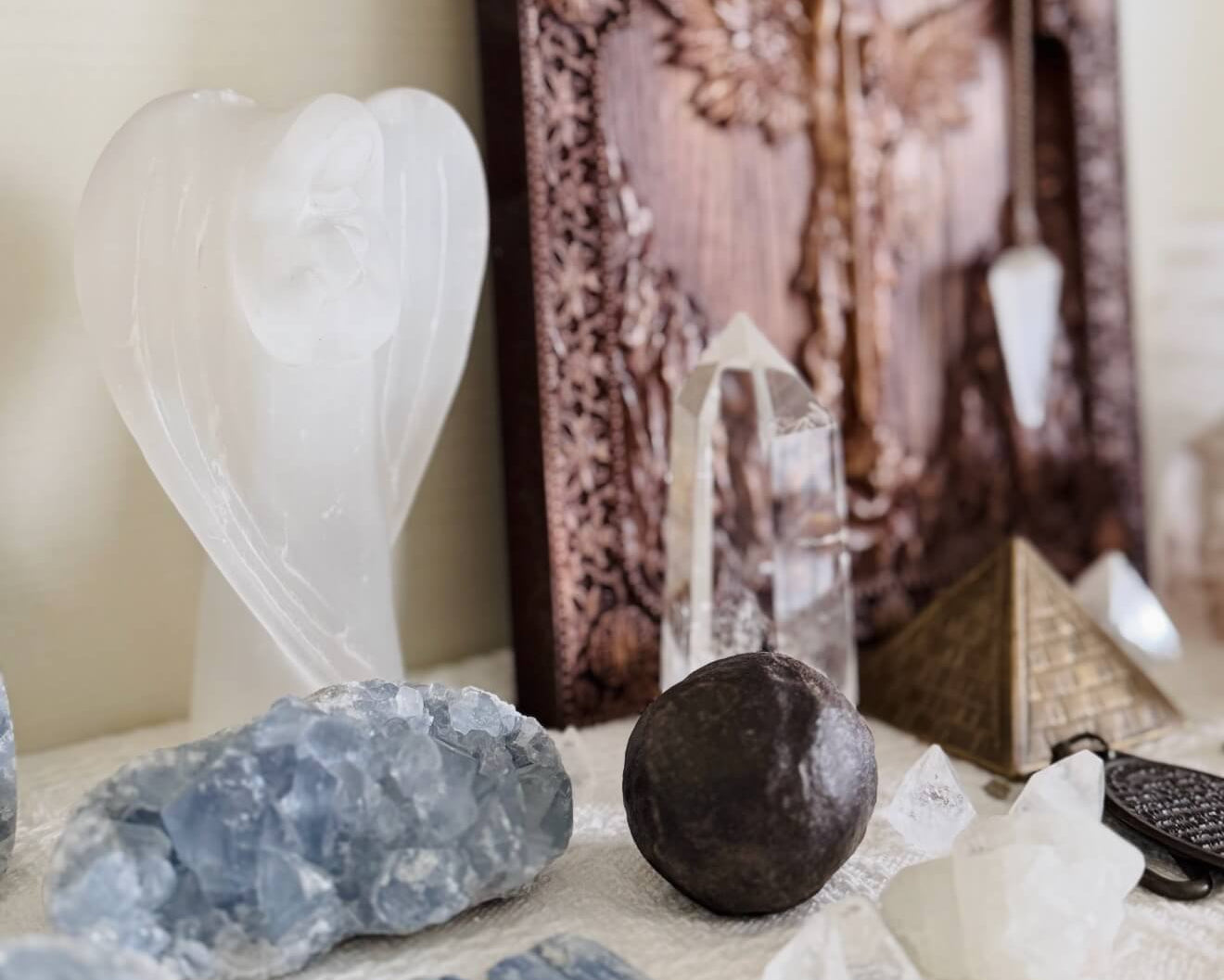 Hand-polished CIRCLEARA crystal stone placed on an open book, symbolizing the connection between personal stories and meaningful physical objects.