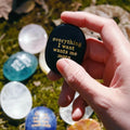 Black manifestation stone with gold engraving 'everything I want wants me more' for meditation and mindfulness