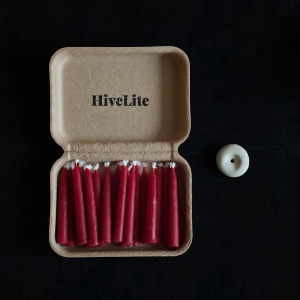 Handcrafted 20-minute Crimson Velvet beeswax meditation candle set by CIRCLEARA, featuring slim red taper candles in a sustainable kraft package with a minimalist ceramic holder.