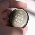CIRCLEARA "Golden Ticket" manifest stone. Deep sheen mineral with gold-etched motivational mantra, designed as a tactile artifact for owning your abundance.