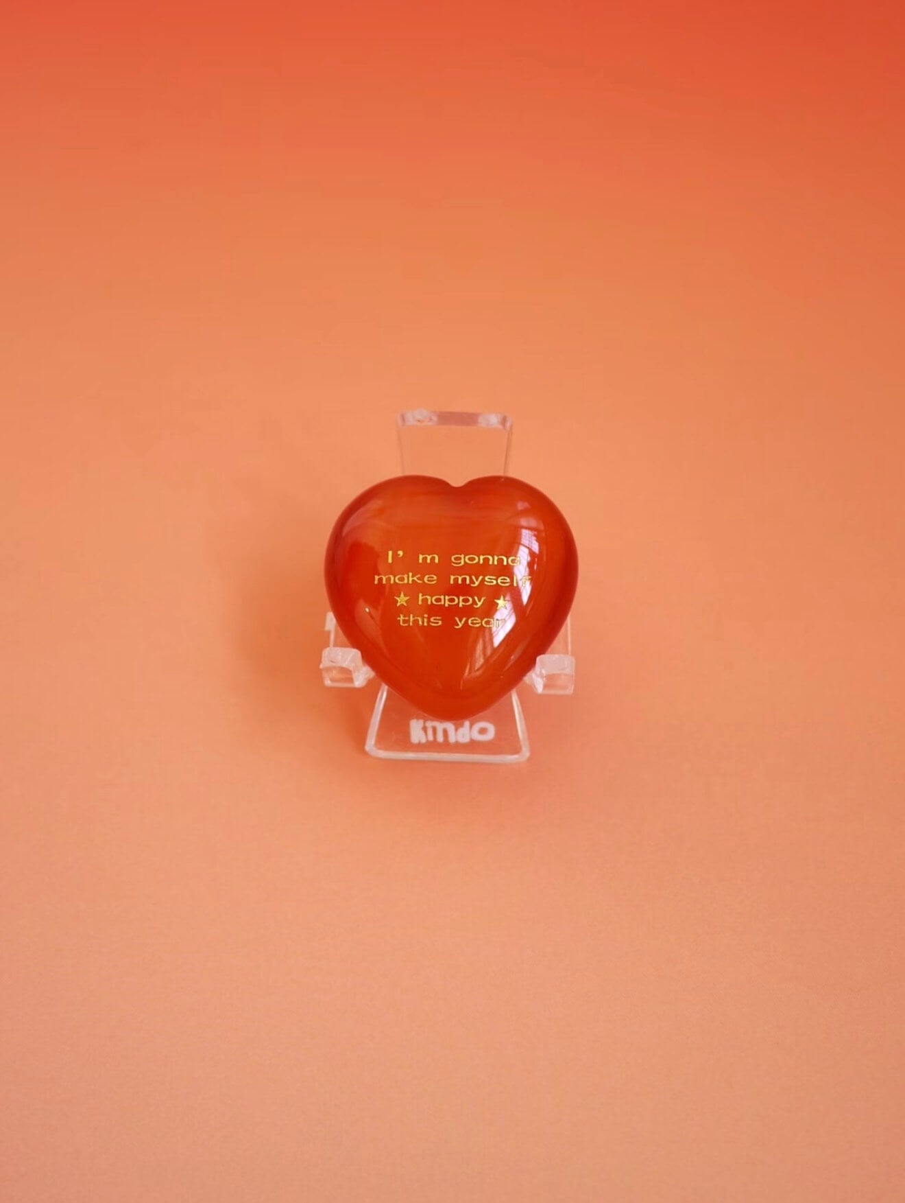 CIRCLEARA "Self-Happy" etched Carnelian heart. A tactile grounding mineral for emotional warmth and vitality, presented as a symbolic 'mental meal' on a dinner plate to represent self-care.
