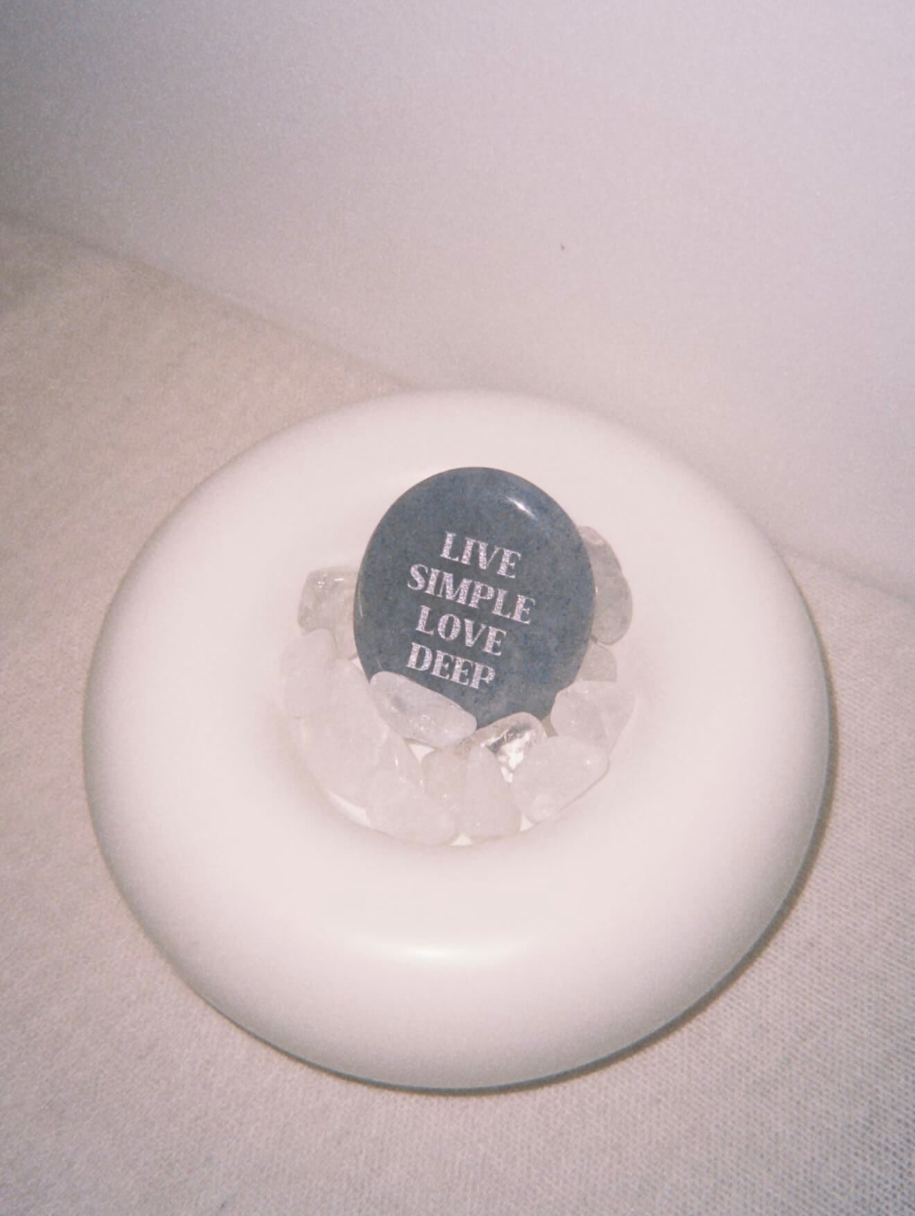 CIRCLEARA "Live Simple, Love Deep" etched Blue Dumortierite stone. A tactile calming mineral designed for the "Soulful Minimalist," serving as an anchor of patience and intentional living.
