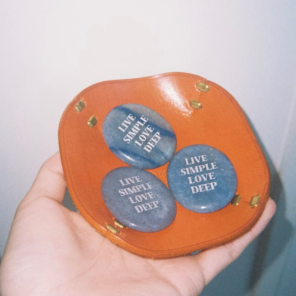 CIRCLEARA "Live Simple, Love Deep" etched Blue Dumortierite stone. A tactile calming mineral designed for the "Soulful Minimalist," serving as an anchor of patience and intentional living.