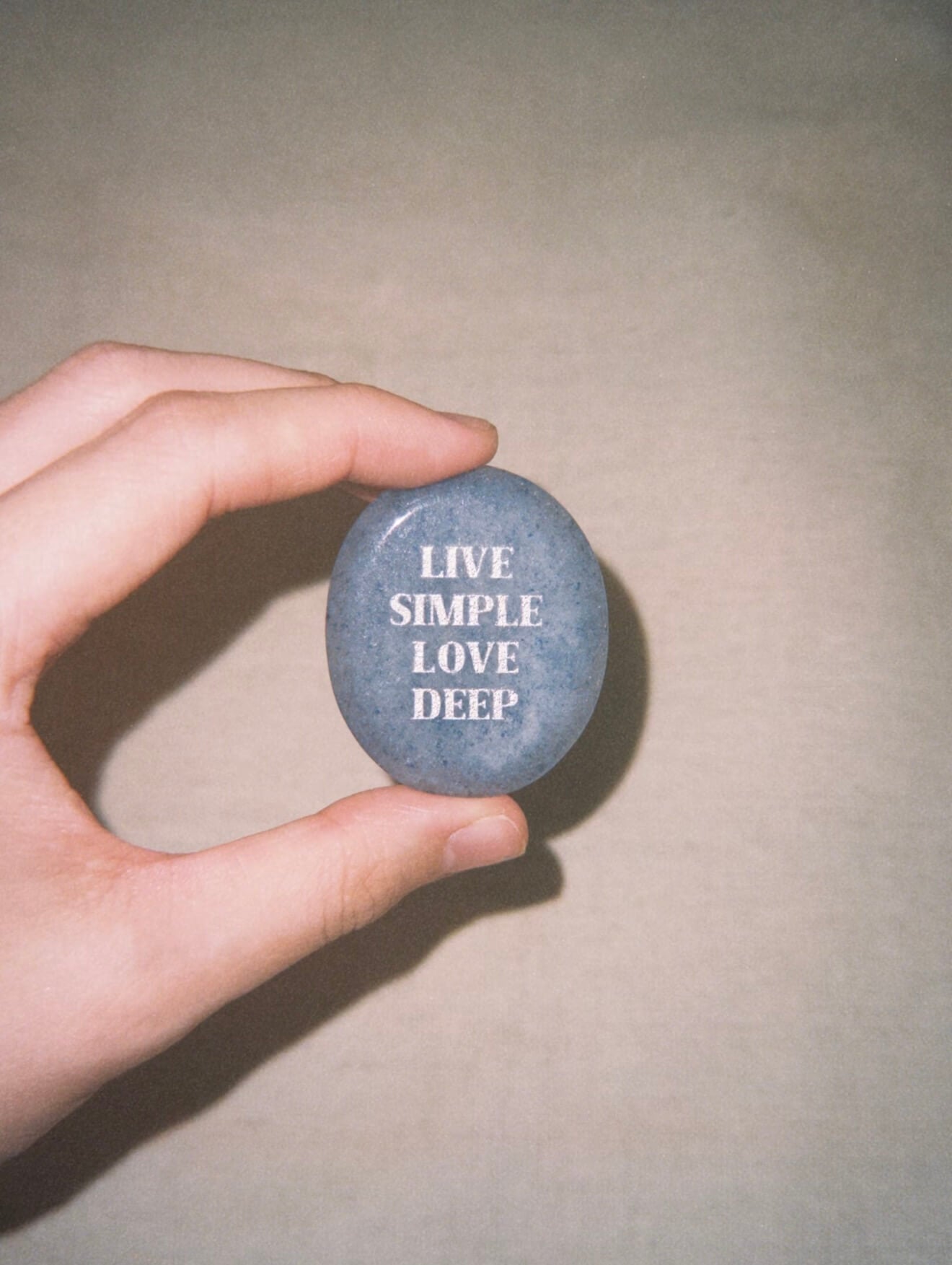 CIRCLEARA "Live Simple, Love Deep" etched Blue Dumortierite stone. A tactile calming mineral designed for the "Soulful Minimalist," serving as an anchor of patience and intentional living.
