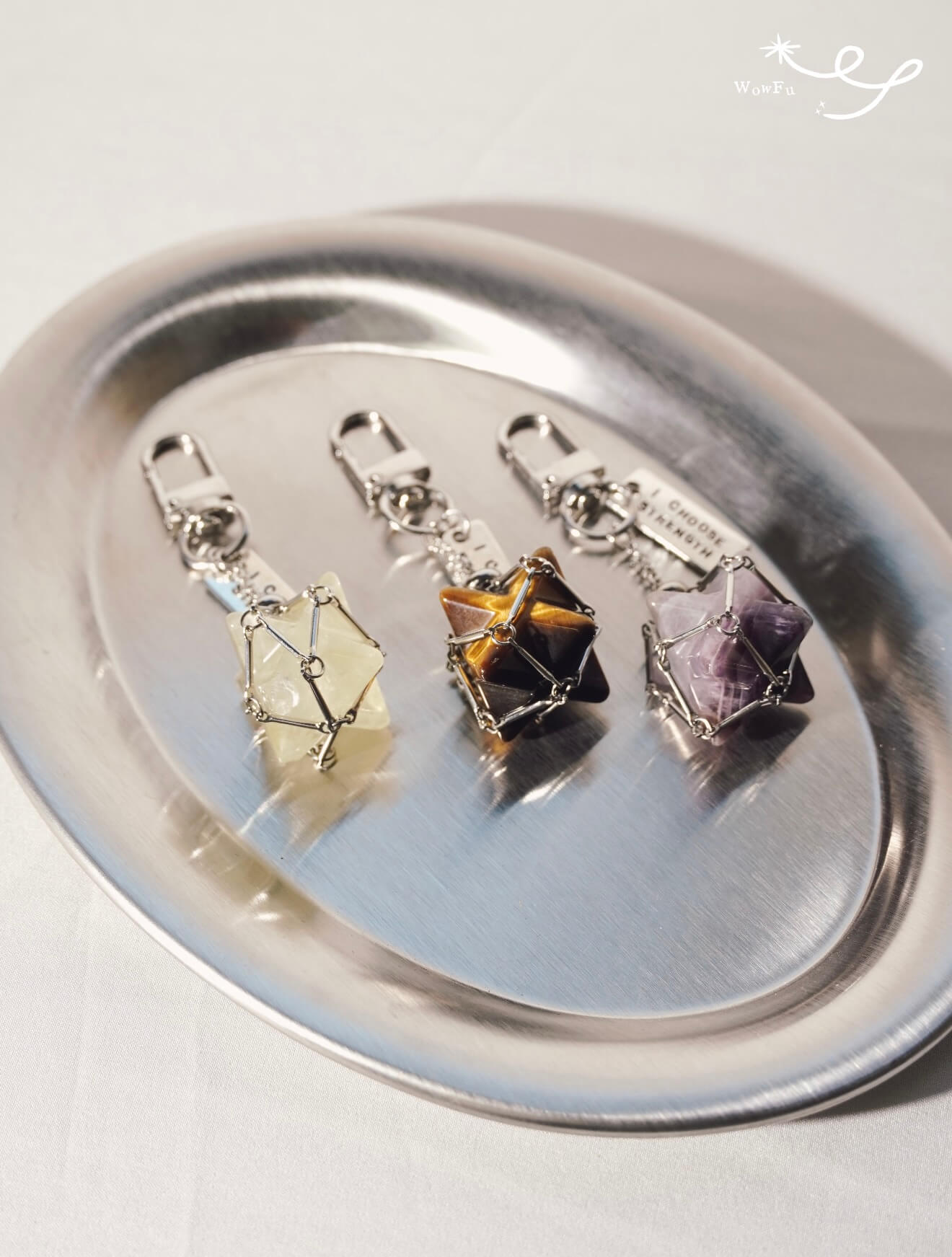 A collection of CIRCLEARA Merkaba star crystal charms with sturdy clips, designed as portable energy anchors for bags and keys.