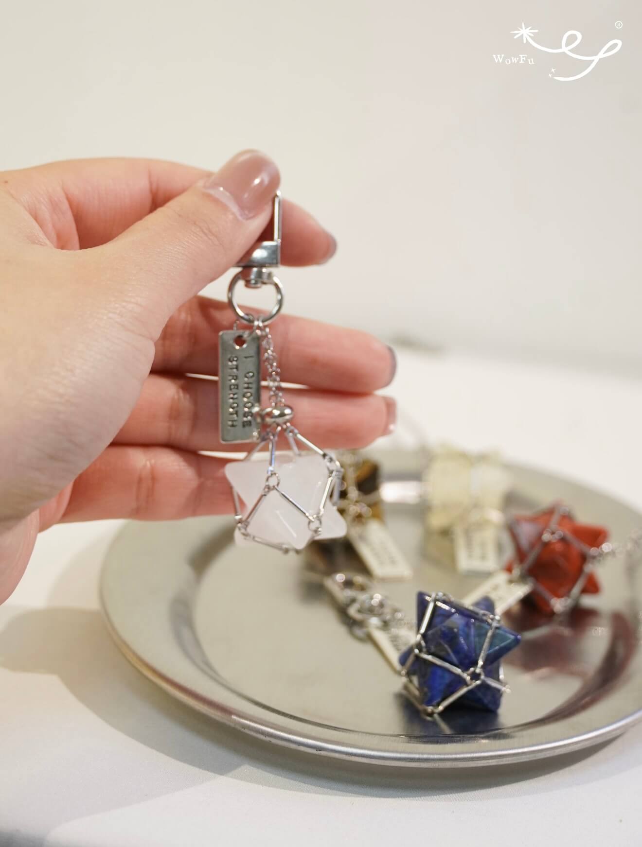 A collection of CIRCLEARA Merkaba star crystal charms with sturdy clips, designed as portable energy anchors for bags and keys.