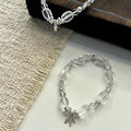 Handcrafted Clear Quartz grounding bracelet featuring smooth, transparent sugar-bean cut crystal beads and 925 sterling silver accents, laid on a clean aesthetic surface.