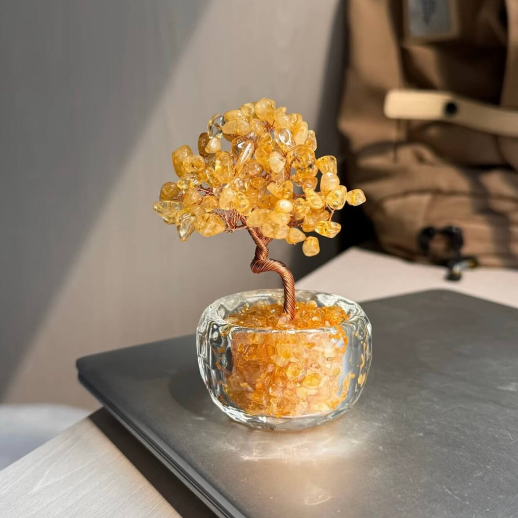 Handcrafted Citrine crystal and copper wire energy tree desk ornament with a minimalist clear glass base filled with golden crystal fragments.