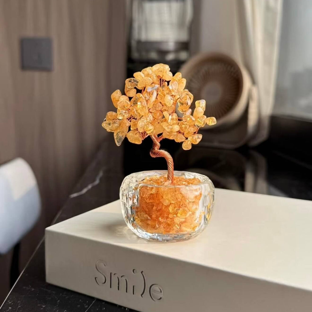 Handcrafted Citrine crystal and copper wire energy tree desk ornament with a minimalist clear glass base filled with golden crystal fragments.