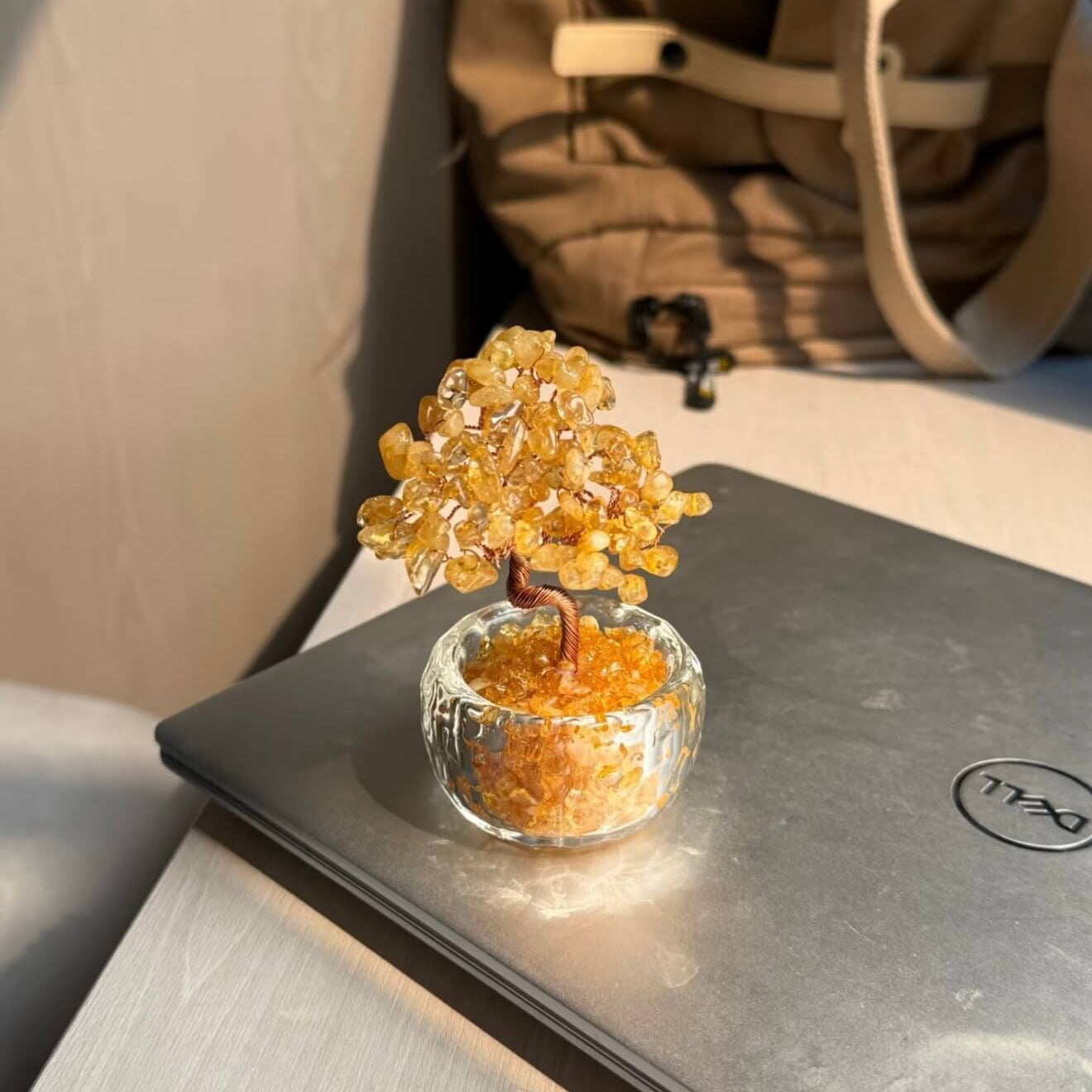 Handcrafted Citrine crystal and copper wire energy tree desk ornament with a minimalist clear glass base filled with golden crystal fragments.