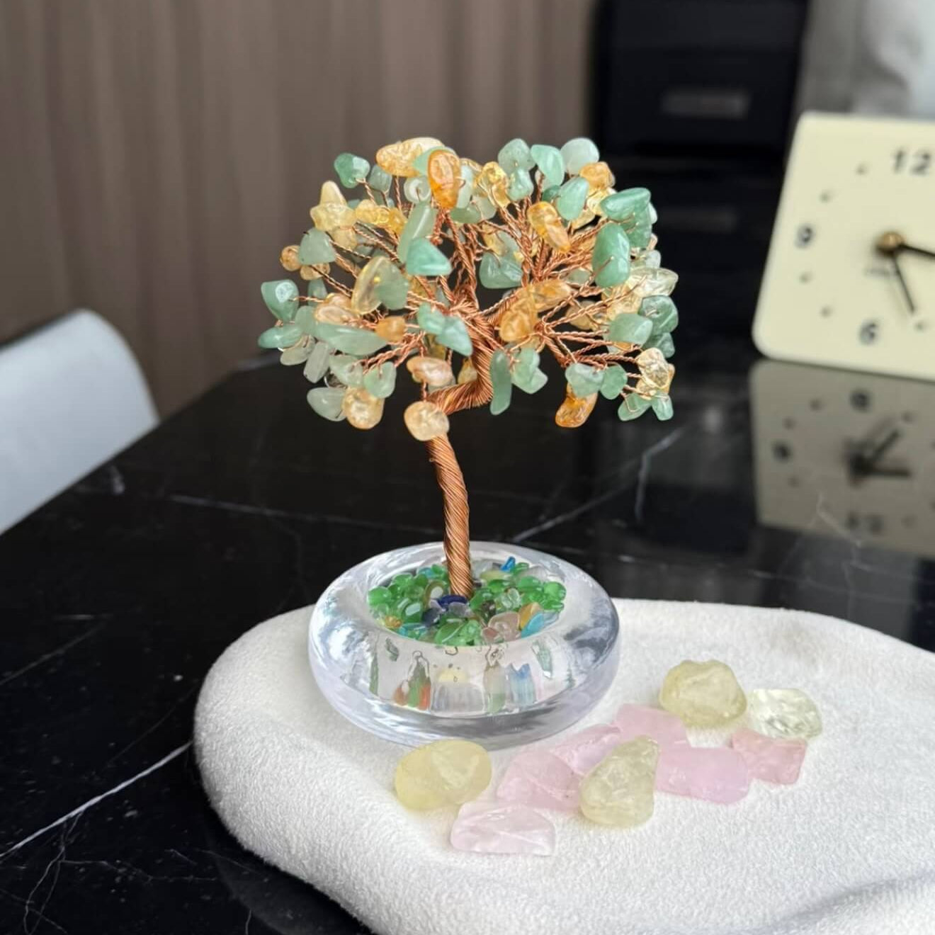 Handcrafted luminous green and yellow Cat's Eye crystal energy tree desk ornament with a minimalist clear glass base filled with translucent crystal fragments.