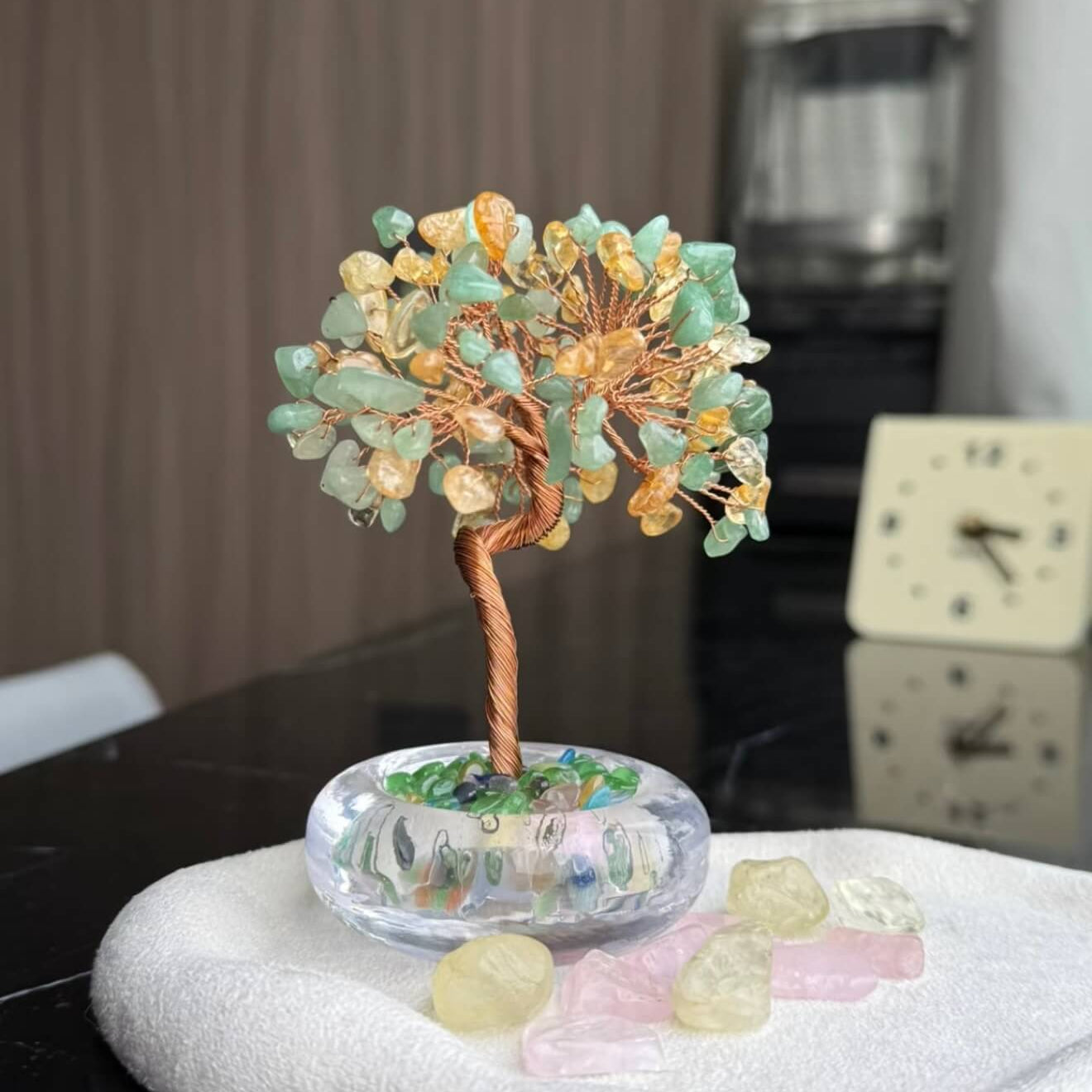 Handcrafted luminous green and yellow Cat's Eye crystal energy tree desk ornament with a minimalist clear glass base filled with translucent crystal fragments.