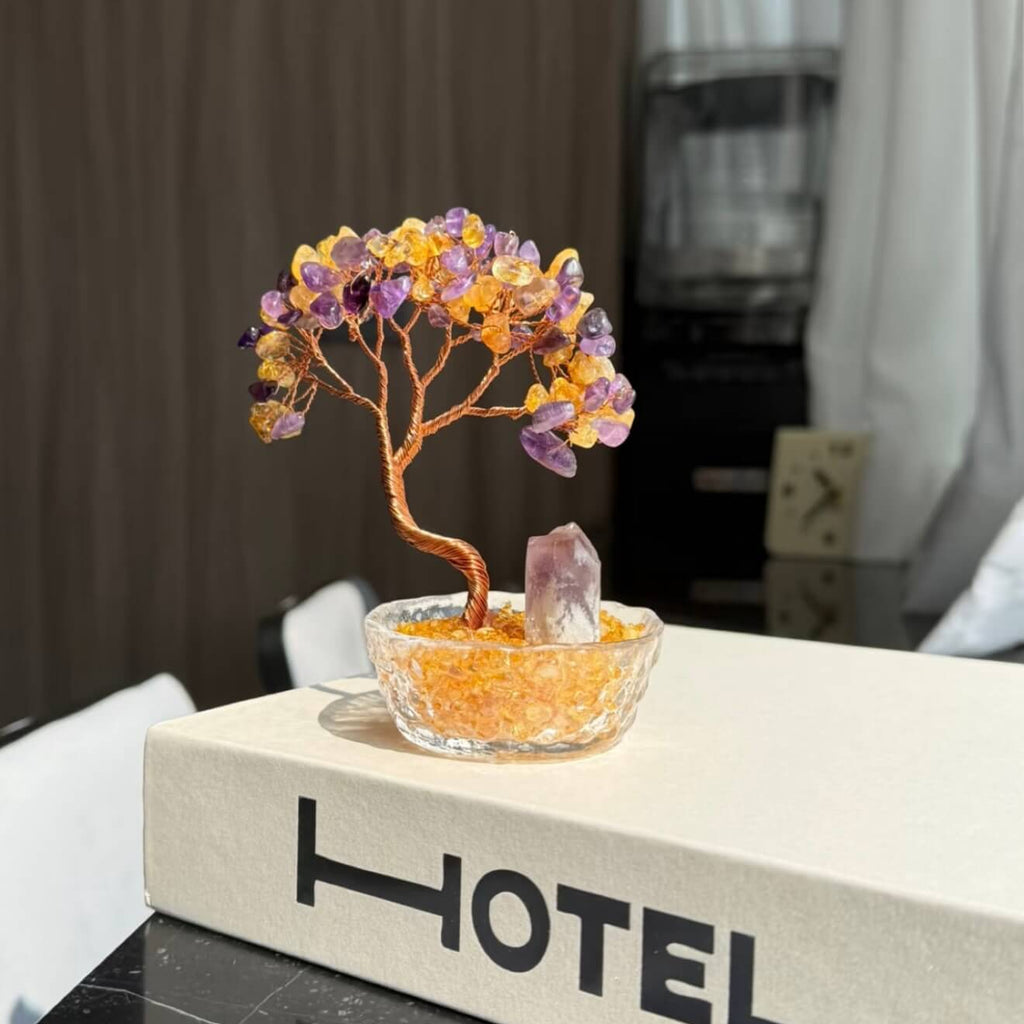 Handcrafted Amethyst and Citrine crystal energy tree desk ornament, featuring a raw, uncut Amethyst pillar anchor in a clear glass basin with golden crystal chips.