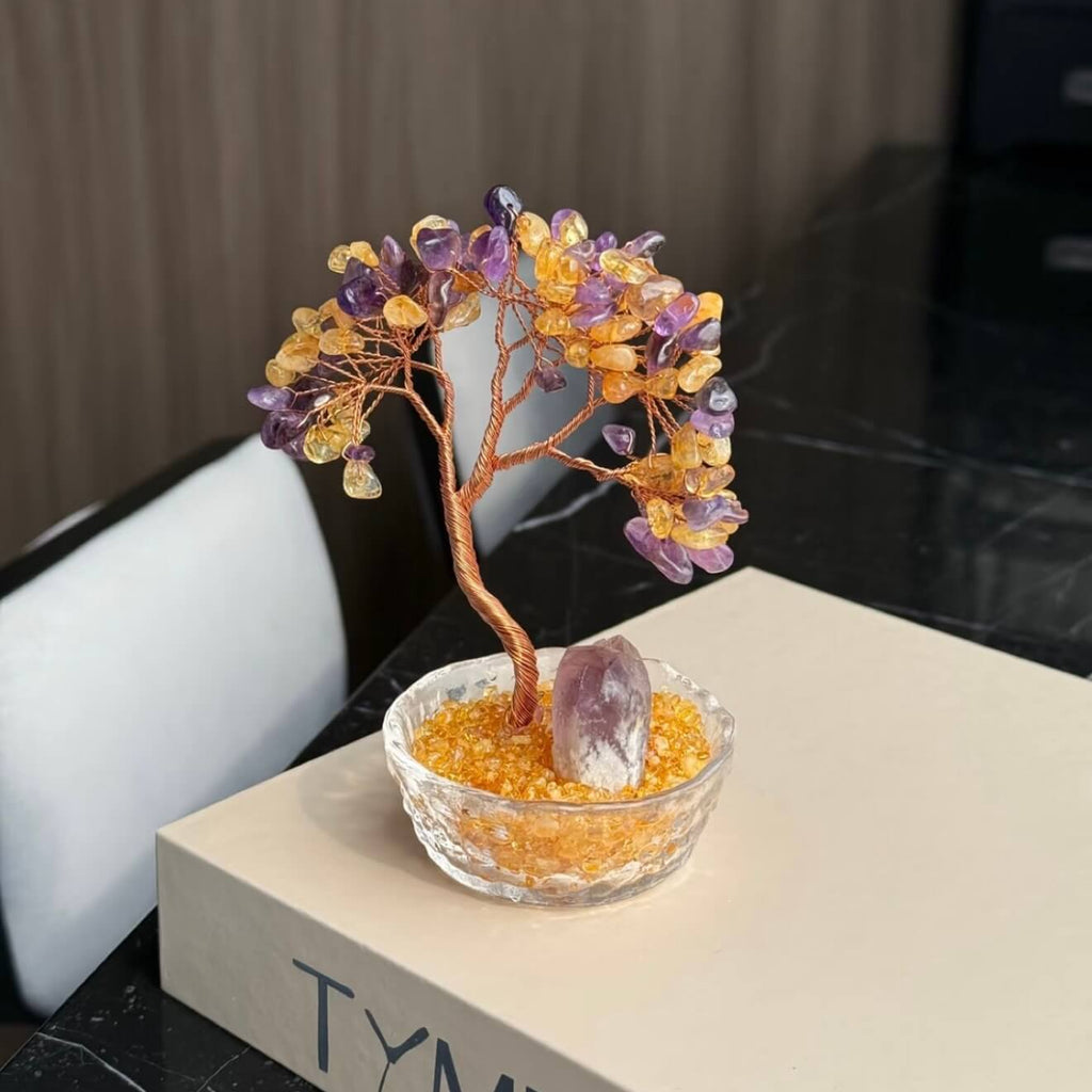 Handcrafted Amethyst and Citrine crystal energy tree desk ornament, featuring a raw, uncut Amethyst pillar anchor in a clear glass basin with golden crystal chips.