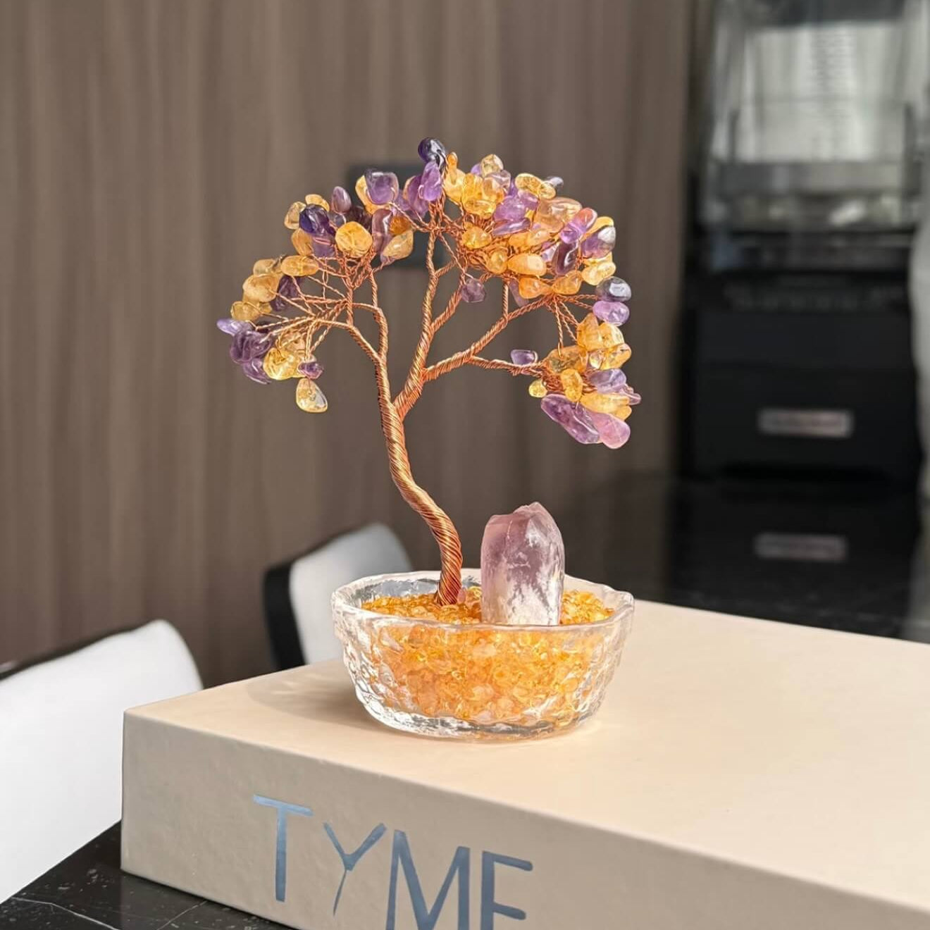 Handcrafted Amethyst and Citrine crystal energy tree desk ornament, featuring a raw, uncut Amethyst pillar anchor in a clear glass basin with golden crystal chips.