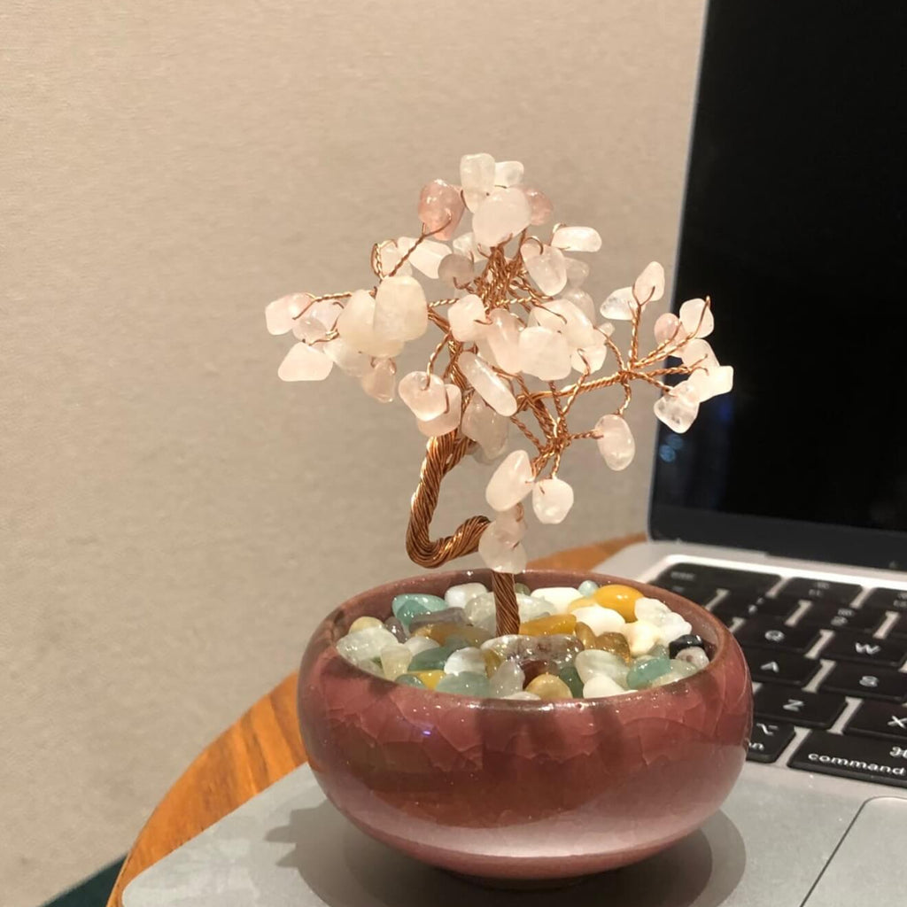 Handcrafted Rose Quartz crystal and copper wire energy tree desk anchor with a minimalist crackle-glaze ceramic basin filled with pastel crystal fragments.