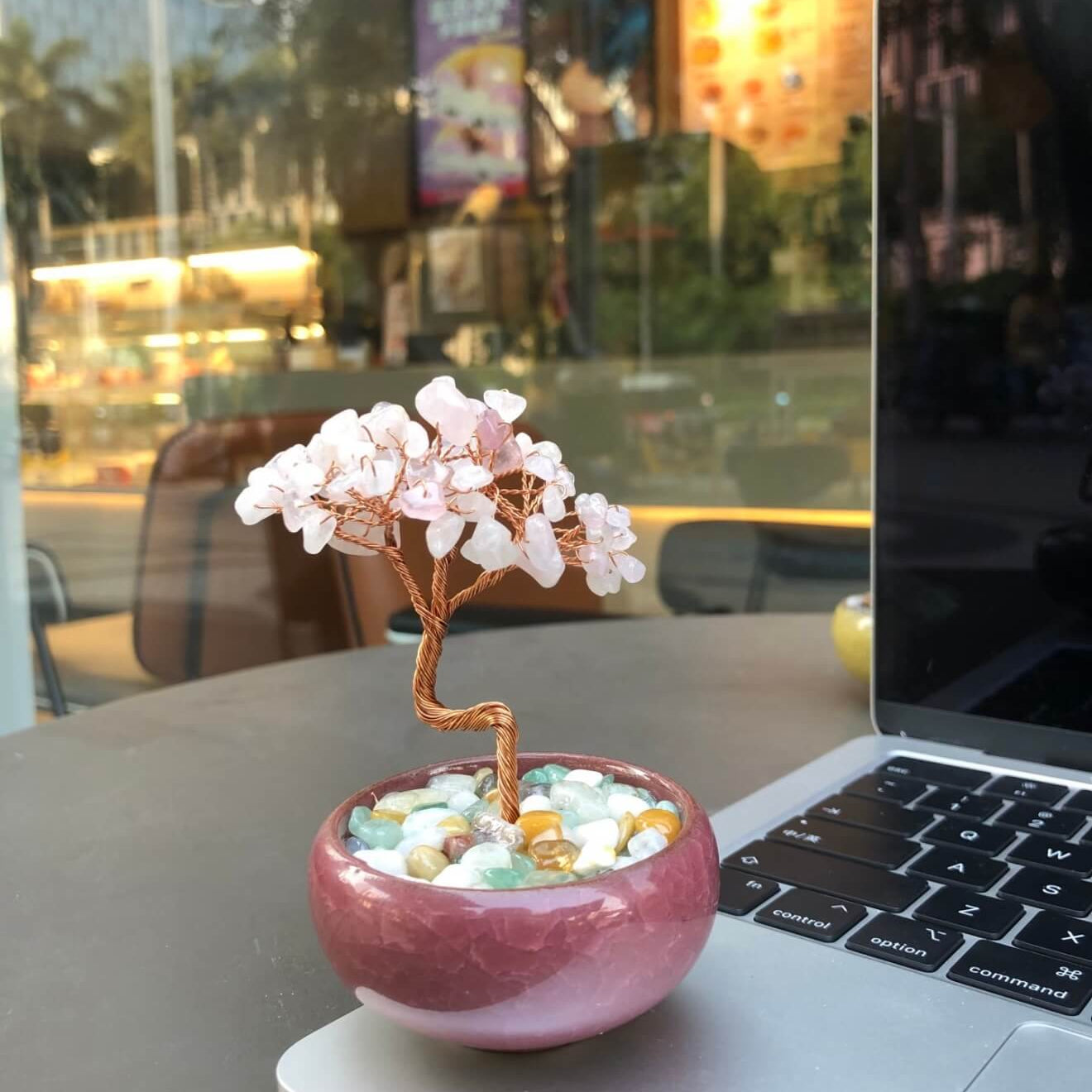 Handcrafted Rose Quartz crystal and copper wire energy tree desk anchor with a minimalist crackle-glaze ceramic basin filled with pastel crystal fragments.