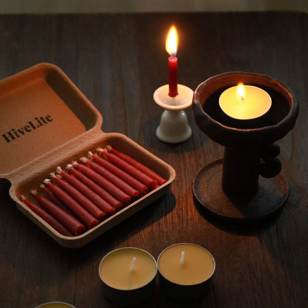 Handcrafted 20-minute Crimson Velvet beeswax meditation candle set by CIRCLEARA, featuring slim red taper candles in a sustainable kraft package with a minimalist ceramic holder.