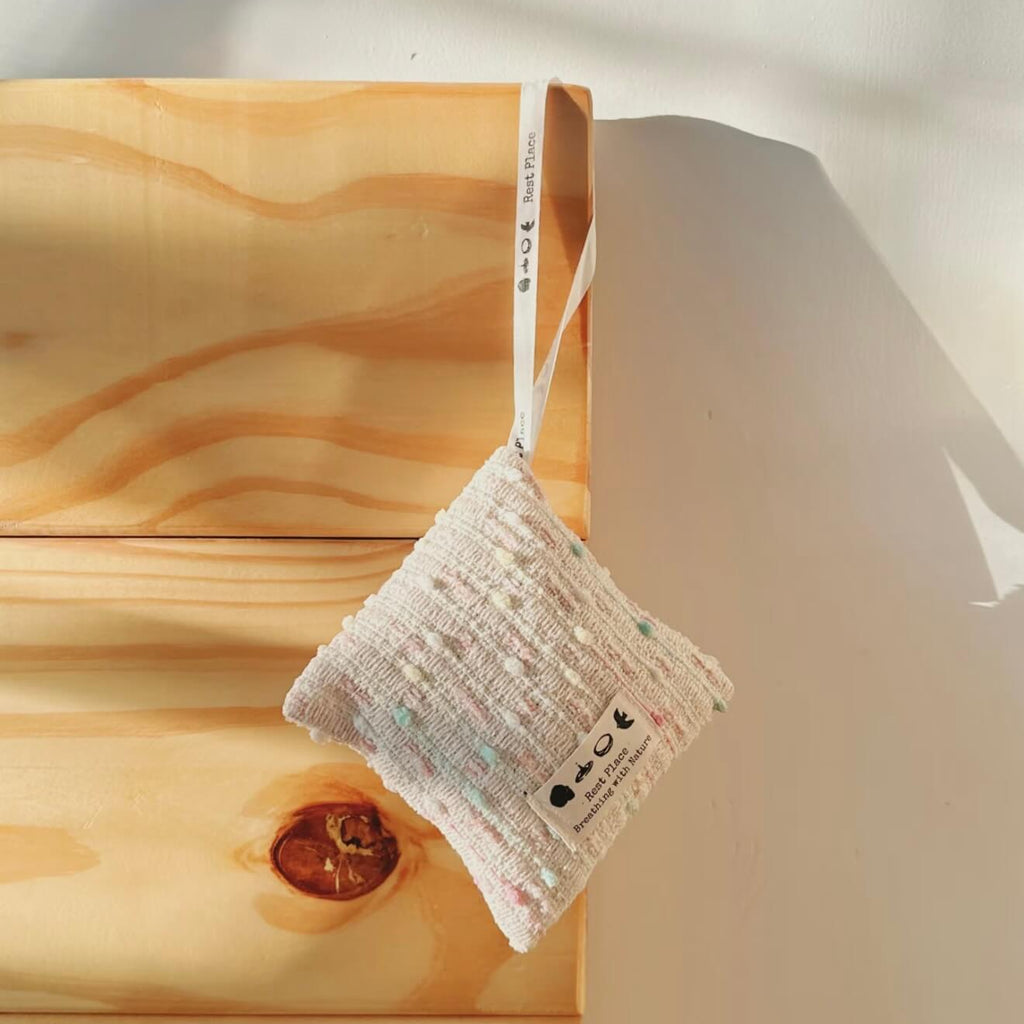 Visual display of rose petals, cinnamon sticks, and citrus peel, highlighting the natural botanical formula of the Fire Ember sachet.
