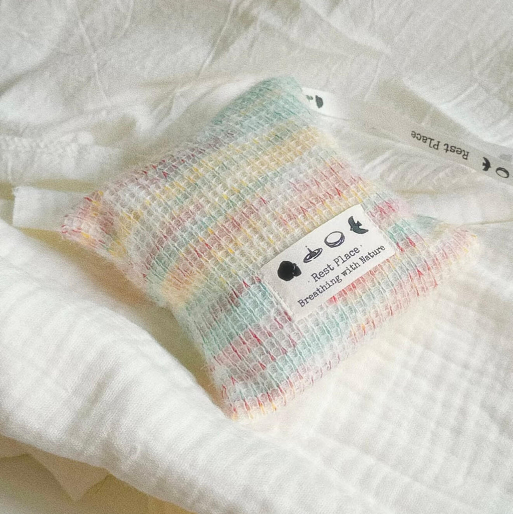 Handcrafted Earth Haven herbal balance sachet by CIRCLEARA, featuring a multi-color artisan woven pouch filled with premium natural lavender and cedarwood botanical herbs.