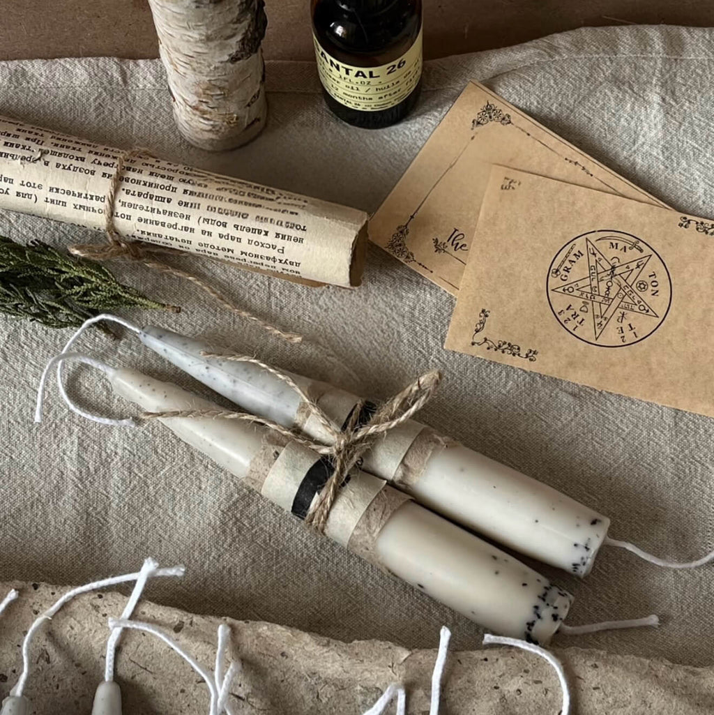 Handcrafted Valley Café coffee-infused soy and beeswax taper candle by CIRCLEARA, featuring a raw, textured surface with natural pinholes and fissures, lit on a minimalist aesthetic background.