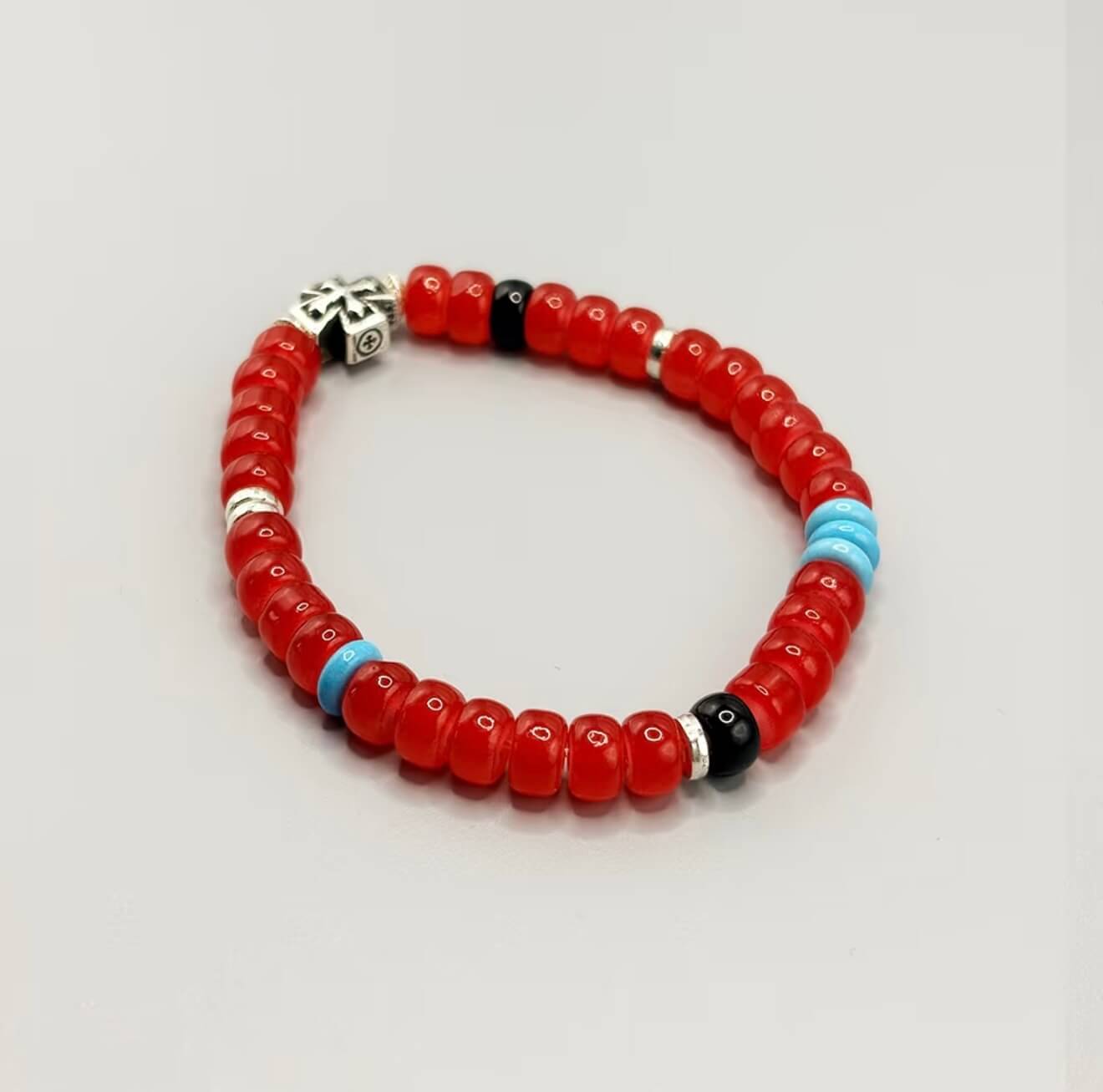 CIRCLEARA Crimson Compass Men's Bracelet with red glaze beads and silver cross. A tactile grounding tool and minimalist gift for daily focus.
