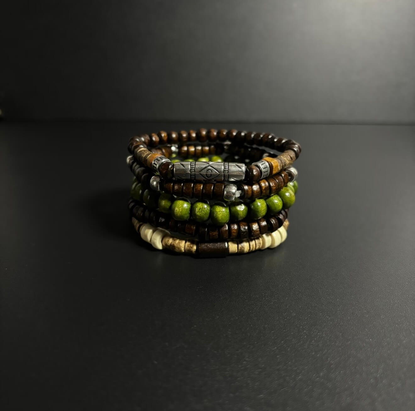 CIRCLEARA Terrane Nomadic Stack: 5-piece wooden bead bracelet set in forest green and charcoal. A minimalist grounding gift for couples and nature lovers.