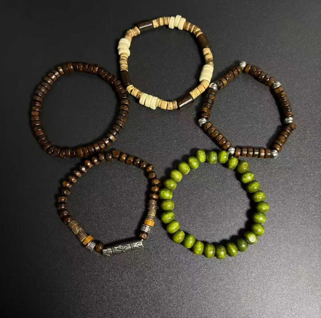 Handcrafted Terrane Nomadic Stack 5-piece wooden bead bracelet set in forest green and charcoal, featuring varied organic textures and weathered alloy spacers for grounding and couples' gifts.