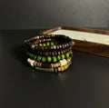 Handcrafted Terrane Nomadic Stack 5-piece wooden bead bracelet set in forest green and charcoal, featuring varied organic textures and weathered alloy spacers for grounding and couples' gifts.