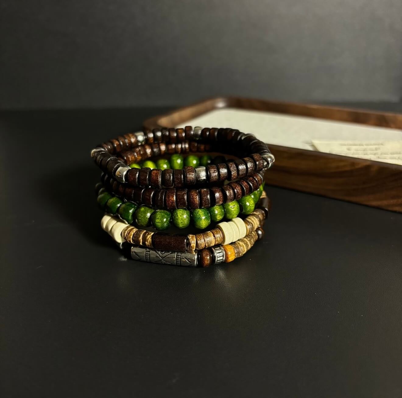 CIRCLEARA Terrane Nomadic Stack: 5-piece wooden bead bracelet set in forest green and charcoal. A minimalist grounding gift for couples and nature lovers.