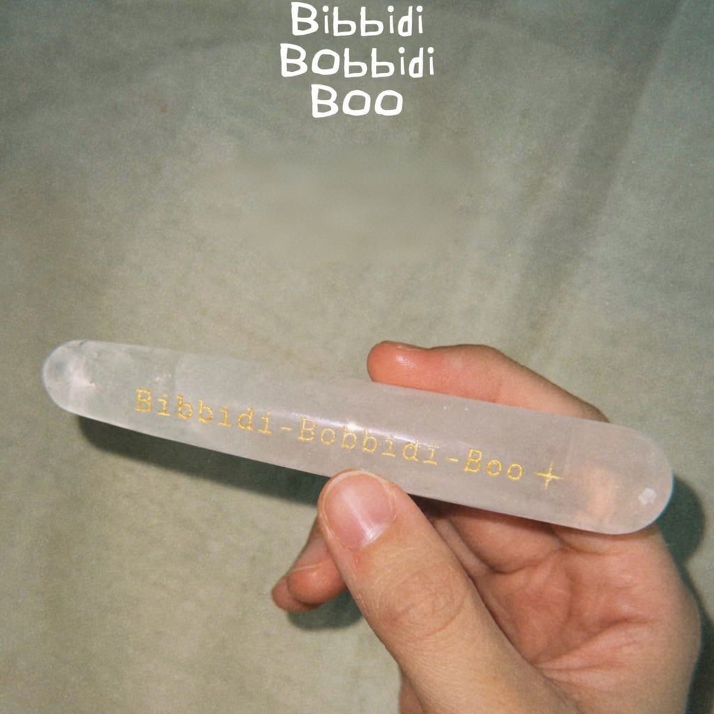 Handcrafted natural clear quartz magic wand engraved with silver 'Bibbidi-Bobbidi-Boo' and stars by CIRCLEARA, showing internal natural ice-fracture textures.