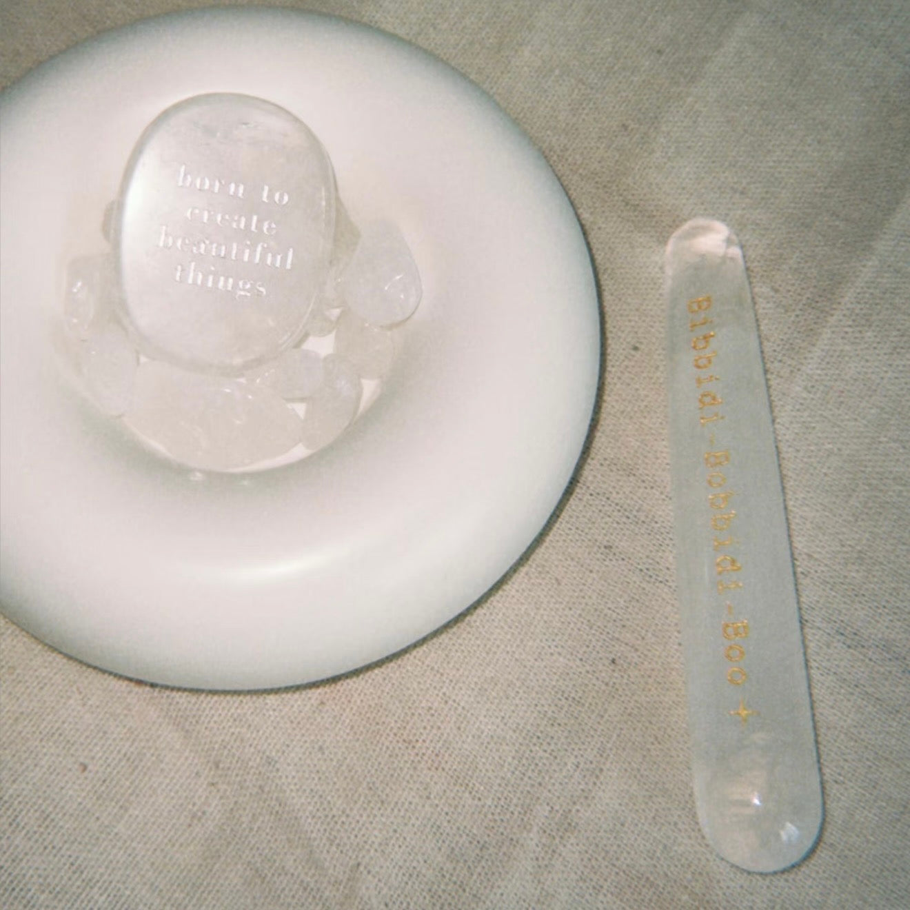 Handcrafted natural clear quartz magic wand engraved with silver 'Bibbidi-Bobbidi-Boo' and stars by CIRCLEARA, showing internal natural ice-fracture textures.