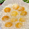 Handcrafted natural golden hematoid yellow quartz palm stones engraved with silver text 'SUN' and a star by CIRCLEARA, displaying vibrant internal inclusions.