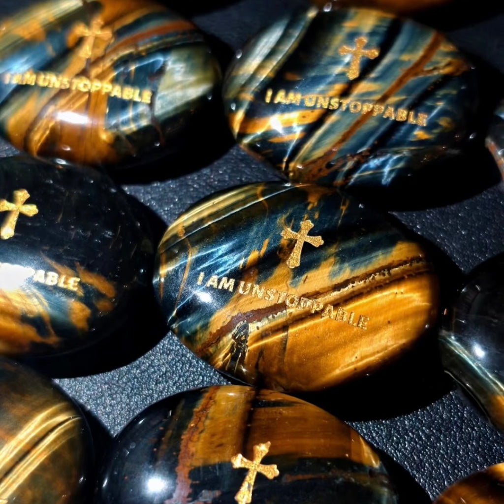 Handcrafted dual Tiger's Eye grounding palm stone by CIRCLEARA, featuring a golden engraved mindfulness quote "I AM UNSTOPPABLE" with rich amber and black banded crystal textures.