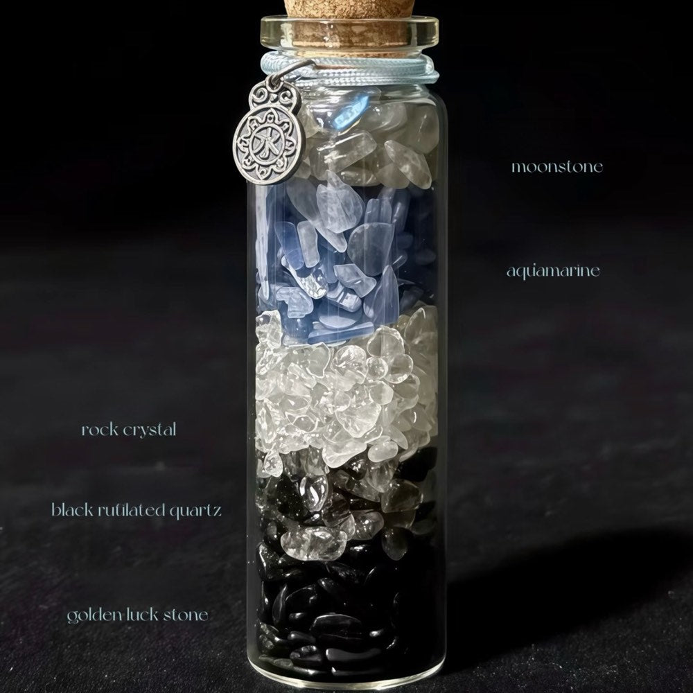 Handcrafted 7x2.2cm glass crystal ritual bottle filled with layered raw mineral chips and a metallic charm by CIRCLEARA.