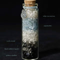 Handcrafted 7x2.2cm glass crystal ritual bottle filled with layered raw mineral chips and a metallic charm by CIRCLEARA.