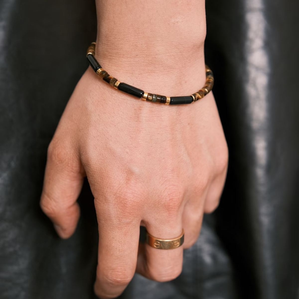 Minimalist men's beaded bracelet featuring polished black obsidian cylindrical bamboo tubes and golden yellow tiger's eye disc spacers by CIRCLEARA.