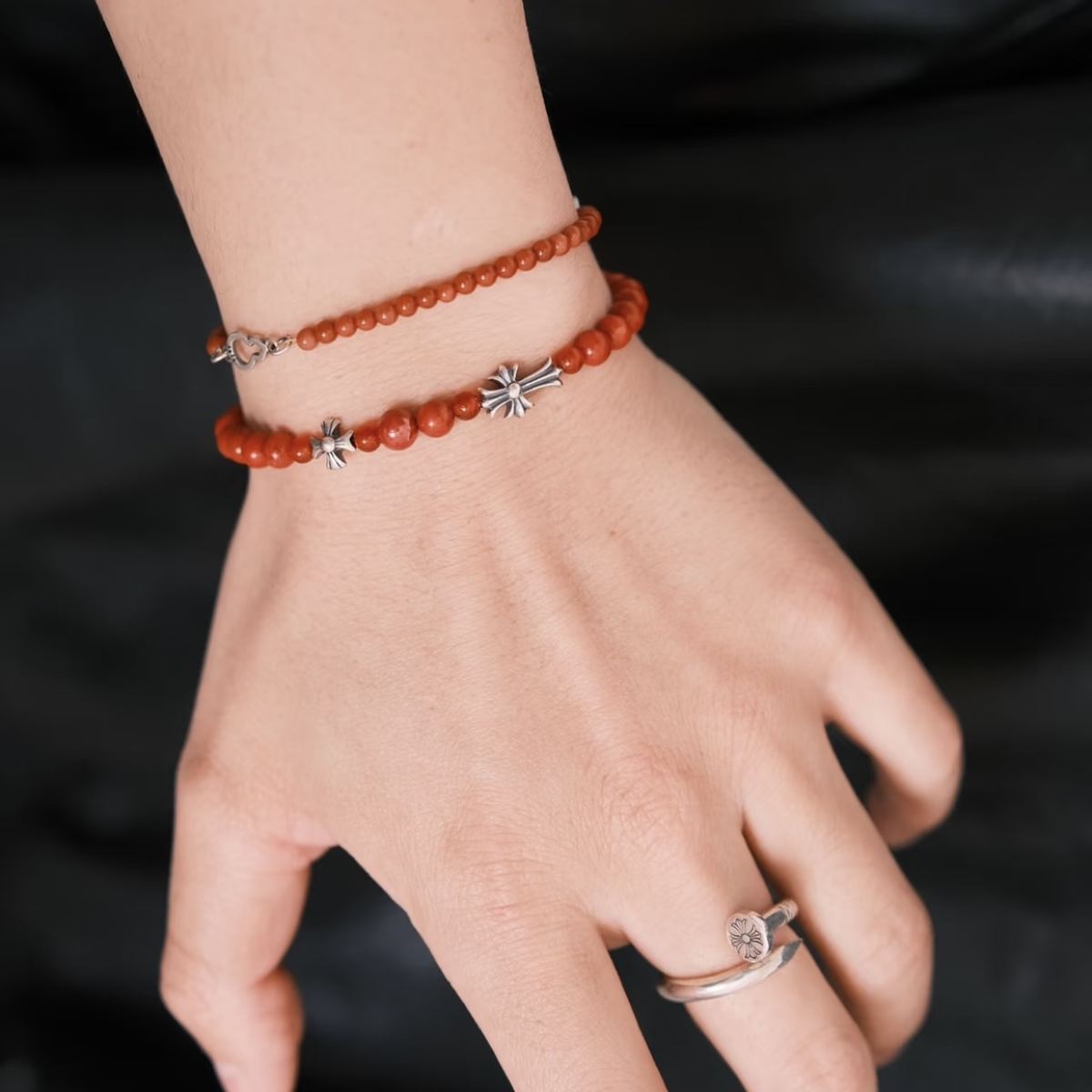Handcrafted 6.3mm natural cherry-red Nanhong agate beaded bracelet with a 925 sterling silver vintage sunburst charm worn on a wrist, by CIRCLEARA.