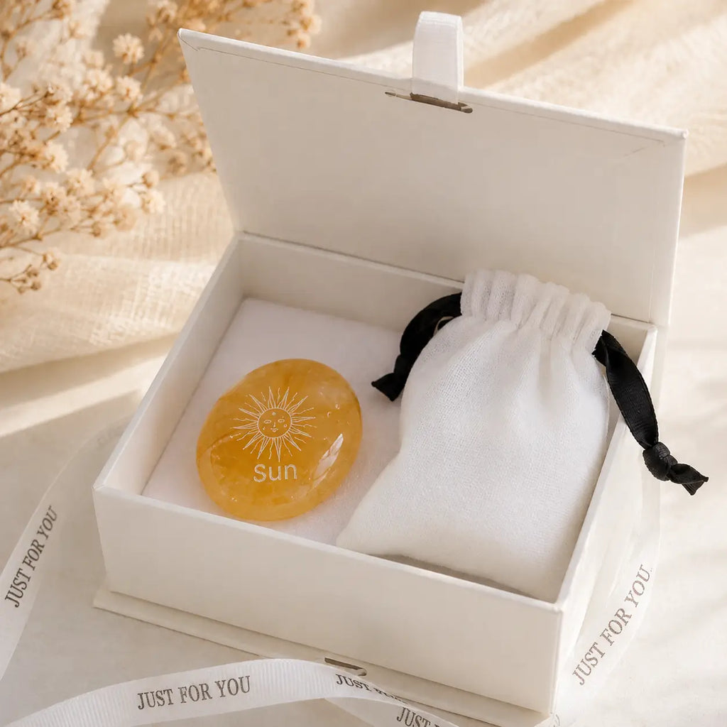 Handcrafted natural golden hematoid yellow quartz palm stones engraved with silver text 'SUN' and a star by CIRCLEARA, displaying vibrant internal inclusions.