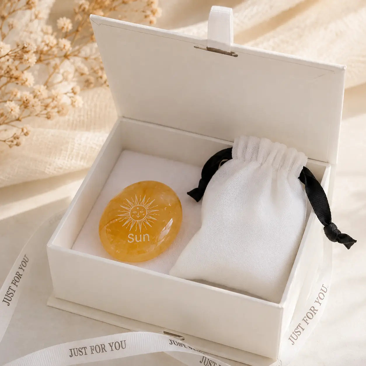 Handcrafted natural golden hematoid yellow quartz palm stones engraved with silver text 'SUN' and a star by CIRCLEARA, displaying vibrant internal inclusions.