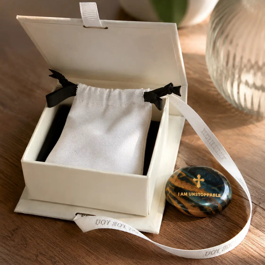 Handcrafted dual Tiger's Eye grounding palm stone by CIRCLEARA, featuring a golden engraved mindfulness quote "I AM UNSTOPPABLE" with rich amber and black banded crystal textures.